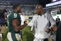 Michigan State coach Mel Tucker, right, congratulates Kenneth Walker III following an NCAA college football game against Western Kentucky, Saturday, Oct. 2, 2021, in East Lansing, Mich. Michigan State won 48-31. (AP Photo/Al Goldis)