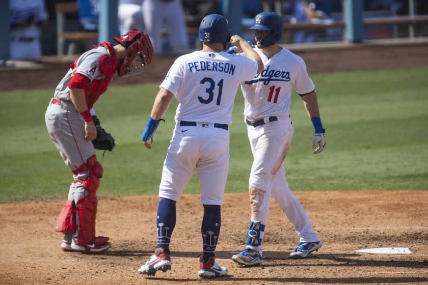 Los Angeles Dodgers' A.J. Pollock, right, celebrates his two-run home run with Joc Pederson, center.