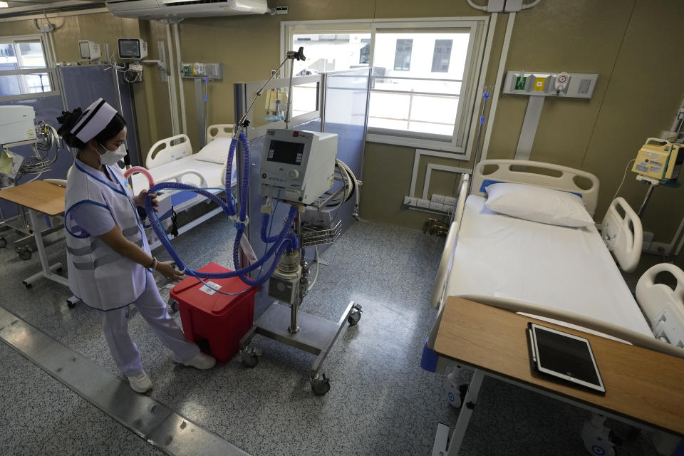 A health worker prepares equipment in a field hospital for COVID-19 patients at the 11th Army Region base in Bangkok, Thailand, Friday, July 2, 2021. As Thailand faces growing numbers of COVID-19 cases and related deaths during a devastating third wave of the coronavirus, there are concerns that it will face a shortage of hospital beds, intensive care units and ventilators for seriously ill patients.(AP Photo/Sakchai Lalit)