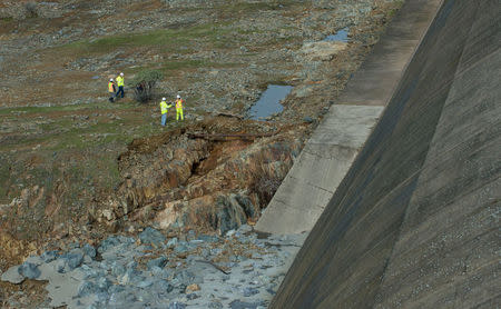 California Department of Water Resources crews inspect and evaluate the erosion just below the Lake Oroville Emergency Spillway site after lake levels receded, in Oroville, California, U.S., February 13, 2017. Kelly M. Grow/ California Department of Water Resources/Handout via REUTERS