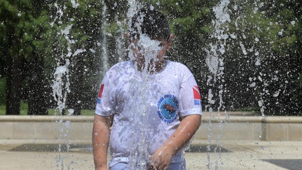 PHOTO: A child cools off in a fountain at Hermann Park, July 3, 2024, in Houston. (Juan Mabromata/AFP via Getty Images)