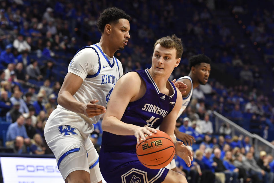 Stonehill guard Shane O'Dell (11) tries to get by Kentucky forward Tre Mitchell (4) during the first half of an NCAA college basketball game in Lexington, Ky., Friday, Nov. 17, 2023. (AP Photo/Timothy D. Easley)