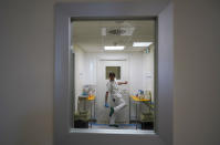 A doctor disinfects his shoes as he leaves the ICU unit of Rome's San Filippo Neri Hospital's Covid department, in Rome, Thursday, April 9, 2020. The new coronavirus causes mild or moderate symptoms for most people, but for some, especially older adults and people with existing health problems, it can cause more severe illness or death. (AP Photo/Andrew Medichini)