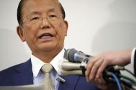 Toshiro Muto, CEO of the Tokyo 2020 Organizing Committee, speaks during a news conference in Tokyo Tuesday, March 17, 2020. Tokyo Olympic organizers are pushing ahead with the Japanese leg of the torch relay that opens on March 26 despite the threat of the spreading coronavirus. Muto said that crowds will not be prohibited from gathering on the roadside. But he asked for restraint and warned the relay could be stopped or delayed. (AP Photo/Eugene Hoshiko)