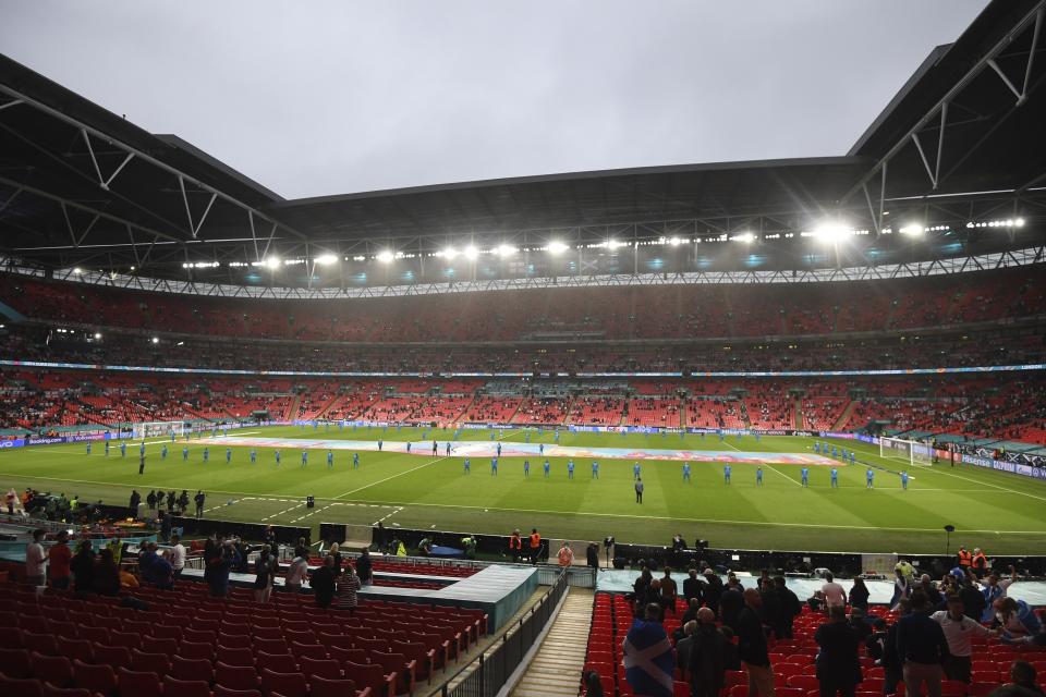 Fans wait for the start of thhe Euro 2020 soccer championship group D match between England and Scotland, at Wembley stadium, in London, Friday, June 18, 2021. (Facundo Arrizabalaga/Pool via AP)