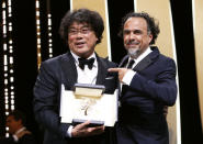 72nd Cannes Film Festival - Closing ceremony - Cannes, France, May 25, 2019. Director Bong Joon-ho, Palme d'Or award winner for his film "Parasite" (Gisaengchung), reacts next to Alejandro Gonzalez Inarritu, Jury President of the 72nd Cannes Film Festival. REUTERS/Stephane Mahe
