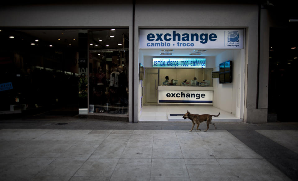 In this June 5, 2013 photo photo, a money exchange shop sits empty along Florida street in Buenos Aires, Argentina. Visitors who turn to the street rather than the banks to swap their dollars are getting a bonanza of extra Argentine pesos and can shop much more cheaply than back at home. (AP Photo/Natacha Pisarenko)