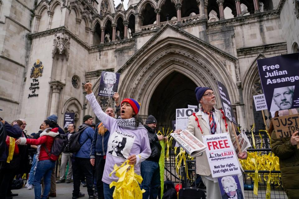 Protesters chant in support of Julian Assange ahead of his appeal hearing at the Royal Courts of Justice on Tuesday (AP)