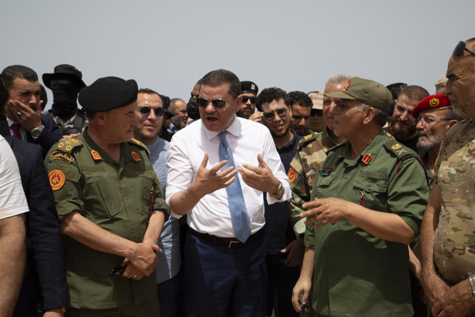 Libyan Prime Minister Prime Minister Abdul Hamid Dbeibah attends the reopening of the road between the cities of Misrata and Sirte Sunday, June 20, 2021. Libya's interim authorities reopened on Sunday the Mediterranean coastal highway linking the country's long-divided eastern and western cities, in the latest bid to reunite the territories after years of civil war. (AP Photo/Yousef Murad)