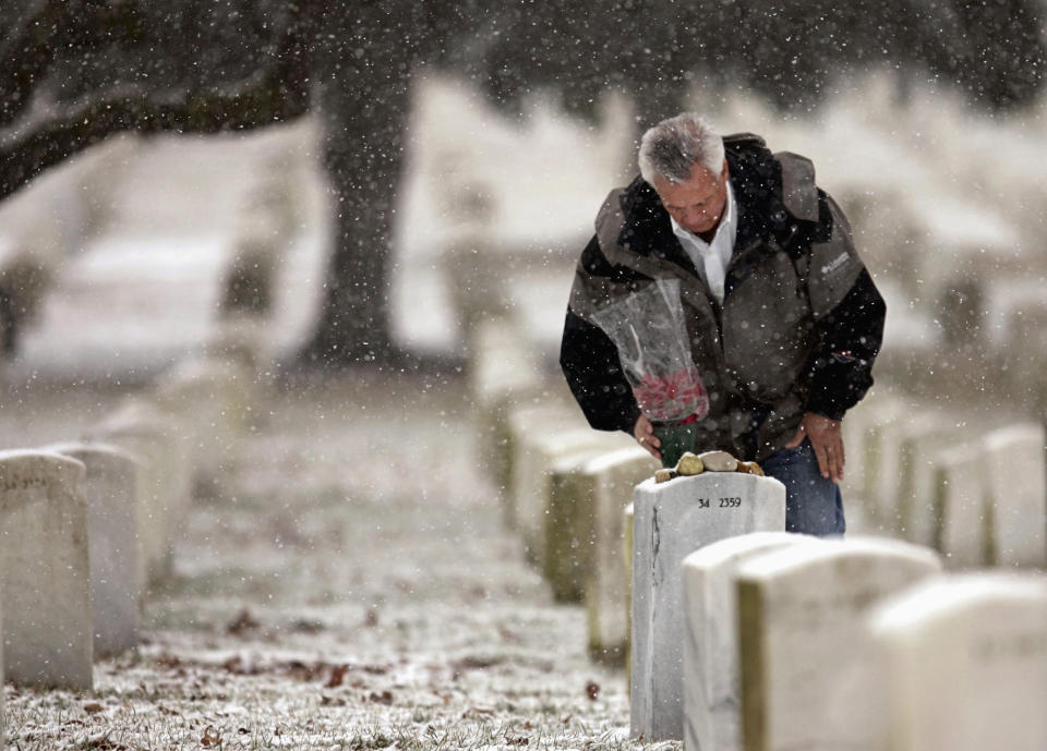 FILE - In this Feb. 28, 2005, file photo, Johnny Spann, father of slain CIA officer Mike Spann of Alabama, who was the first American to die in Afghanistan, pauses at his son's gravesite at Arlington National Cemetery in Arlington, Va. Spann said he is not opposed to Americans leaving Afghanistan but disagrees with the timing and how it was done. (AP Photo/Haraz Ghanbari, File)