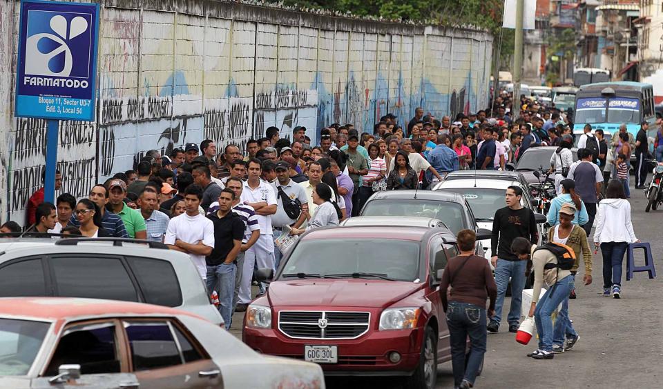 Venezuelans line a street in Caracas, the capital, to vote in national elections in this 2012 photo. Routines of government and everyday life in Venezuela have been strained in recent years and widespread anti-government protests have occurred repeatedly.