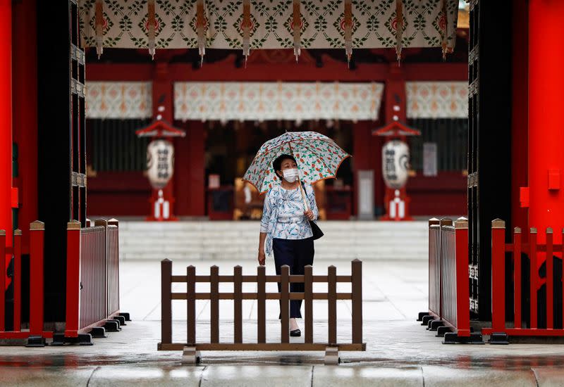 A woman wearing a protective face mask walks amid the coronavirus disease (COVID-19) outbreak, in Tokyo