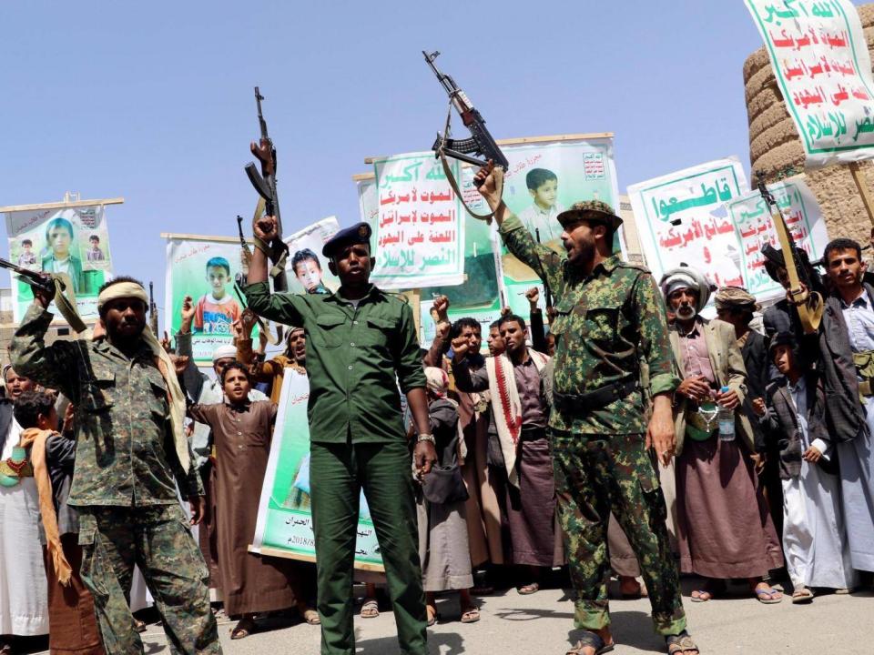 Houthi soldiers protest an offer by the Saudi-led coalition to pay compensation for victims of an airstrike in Saada, Yemen (Reuters)