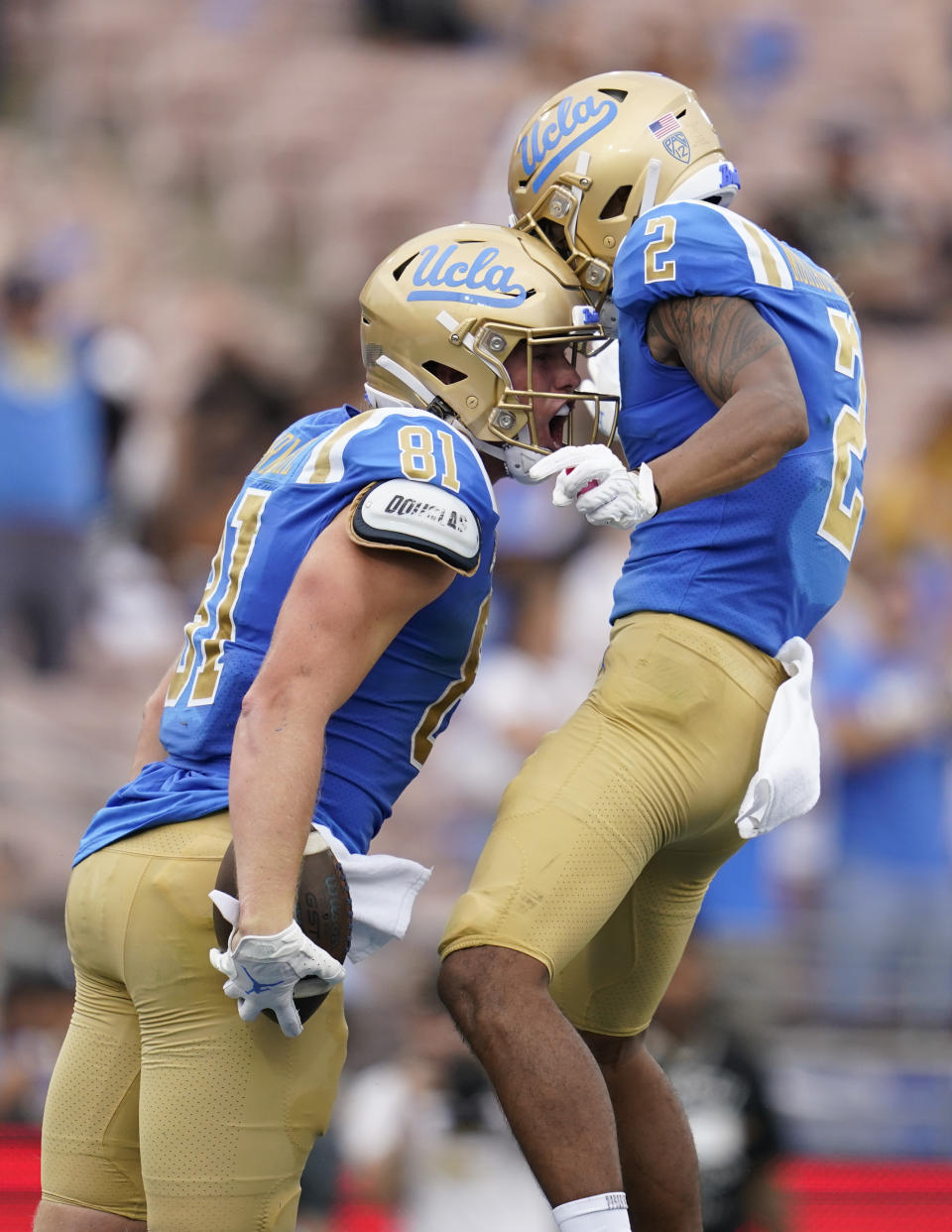 UCLA tight end Hudson Habermehl (81) celebrates with wide receiver Titus Mokiao-Atimalala (2) after scoring a touchdown during the first half of an NCAA college football game against Alabama State in Pasadena, Calif., Saturday, Sept. 10, 2022. (AP Photo/Ashley Landis)