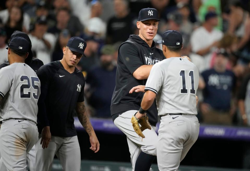 Injured New York Yankees outfielder Aaron Judge, second from right,, congratulates shortstop Anthony Volpe after the team's win in a baseball game against the Colorado Rockies on Saturday, July 15, 2023, in Denver.(AP Photo/David Zalubowski)