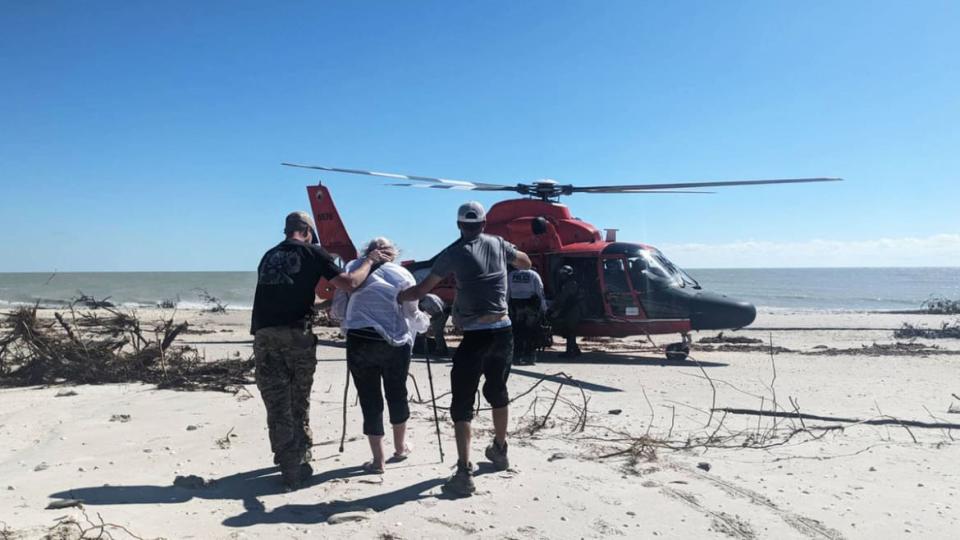 <div class="inline-image__caption"><p>Volunteer Search and Rescuers Chad Smith and Nevin Young escort an older resident off Sanibel Island Friday morning </p></div> <div class="inline-image__credit">CrowdSource Rescue</div>