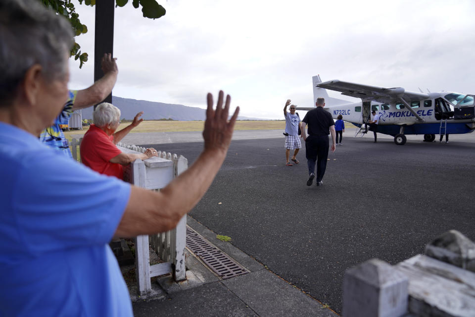 Sister Barbara Jean Wajda, left, and Sister Alicia Damien Lau wave goodbye to their guests, who were allowed a rare post COVID-19 pandemic pilgrimage to Kalaupapa, Hawaii, on Tuesday, July 18, 2023. (AP Photo/Jessie Wardarski)