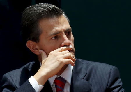 Mexico's President Enrique Pena Nieto reacts during a ceremony to sign into law a new-anti corruption legislation, at the National Palace in Mexico City May 4, 2015. REUTERS/Henry Romero