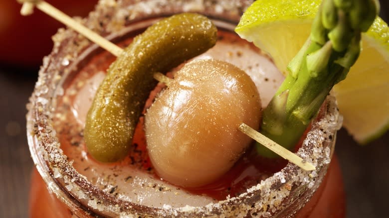 Close-up of a pearl onion garnishing a Bloody Mary