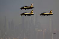 The city skyline in background, as Al Fursan", or the Knights, a UAE Air Force aerobatic display team, prepare for landing during second day of the Dubai Air Show, United Arab Emirates, Tuesday, Nov. 14, 2023. (AP Photo/Kamran Jebreili)