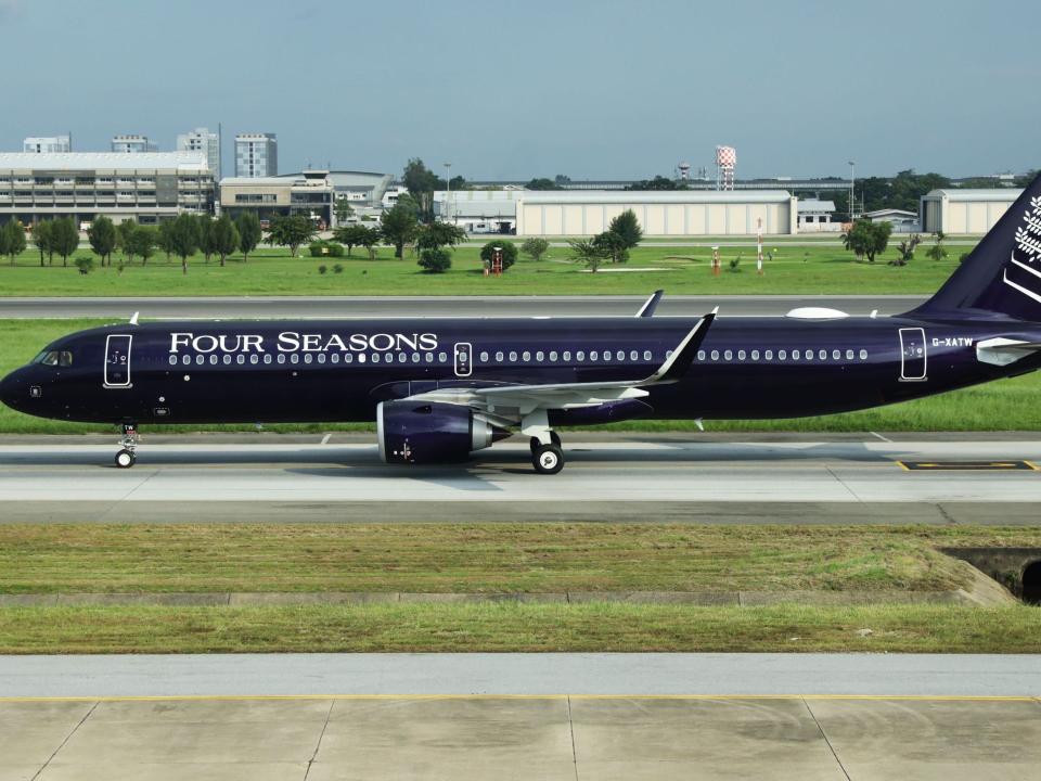 The Four Seasons jet in purple livery and white tree painted on the tail.