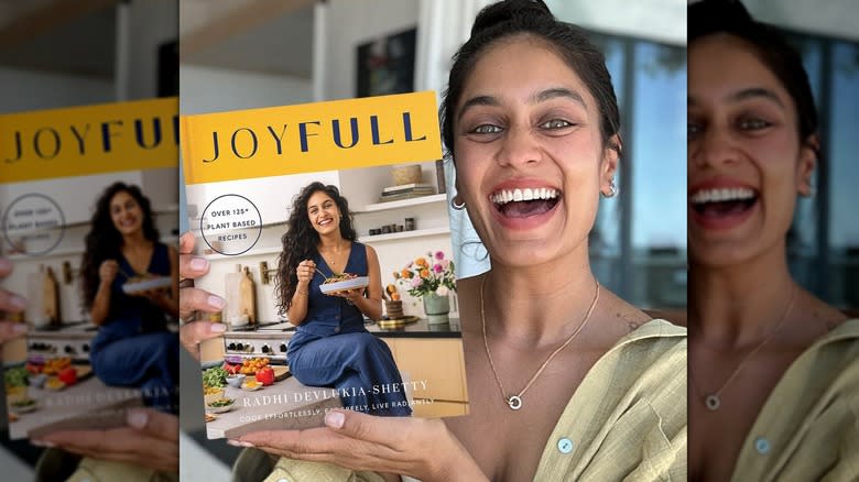 Radhi Devlukia holding a cookbook