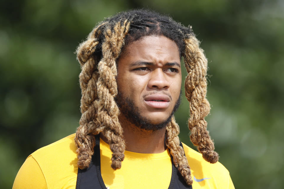 Washington Commanders defensive end Chase Young walks to the field before an NFL football practice at Inova Sports Performance Center in Ashburn, Va., Monday, Aug. 22, 2022. (AP Photo/Luis M. Alvarez)