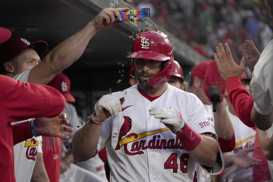 St. Louis Cardinals' Andrew Knizner, left, dumps a package of seeds on teammate Paul Goldschmidt in celebration of Goldschmidt's two-run home run during the sixth inning of a baseball game Monday, June 12, 2023, in St. Louis. (AP Photo/Jeff Roberson)