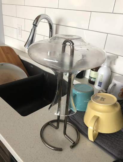 upside down decanter over a paper towel holder