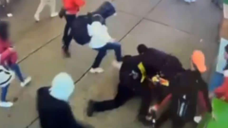 This screengrab from a New York Police Department video shows a group of alleged migrants assaulting two New York Police Department officers near Times Square in late January. - New York Police Department