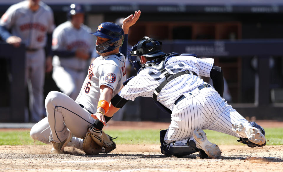 Houston Astros second baseman Aledmys Diaz (16) is tagged out at home by New York Yankees catcher Kyle Higashioka (66) during the inning of a baseball game, Saturday, June 25, 2022, in New York. (AP Photo/Noah K. Murray)