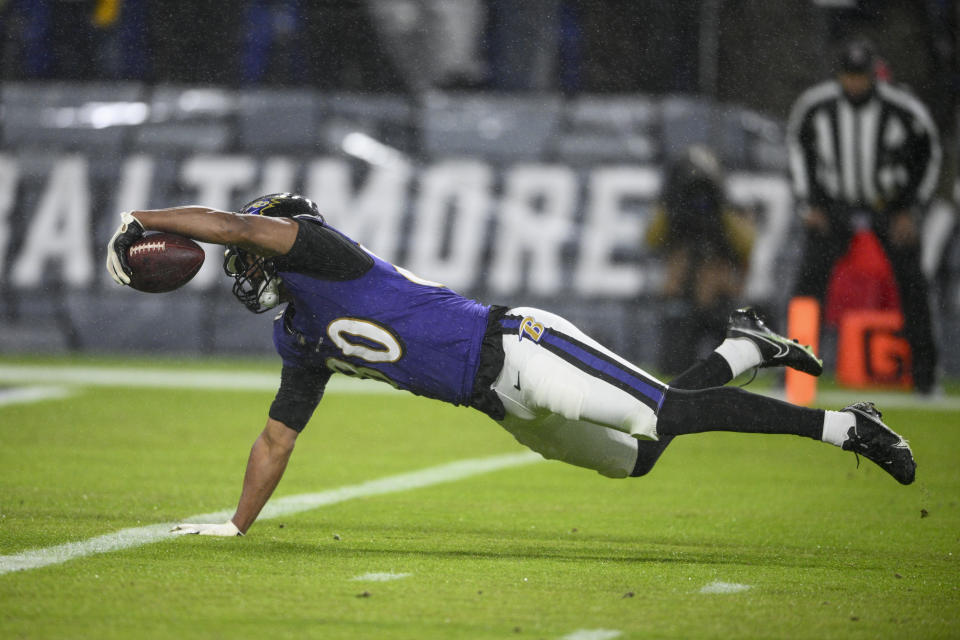 Baltimore Ravens tight end Isaiah Likely dives in for the touchdown after catching a pass from quarterback Tyler Huntley during the first half of an NFL football game against the Pittsburgh Steelers, Saturday, Jan. 6, 2024 in Baltimore. (AP Photo/Nick Wass)