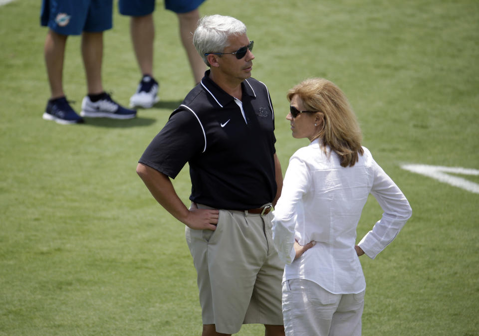 FILE - Miami Dolphins general manager Dennis Hickey, left, watches players do drills with Dawn Aponte, executive vice president of football administration, right, during an NFL football organized team activity, Monday, June 8, 2015, in Davie, Fla. Now the NFL's chief football administrative officer, Aponte began in the NFL in the early 1990s, when women barely felt welcomed and were often ignored or overlooked. (AP Photo/Lynne Sladky, File)