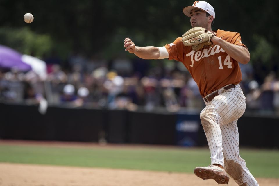 Texas' Murphy Stehly throws out East Carolina's Zach Agnos at first base during the sixth inning of an NCAA college super regional baseball game on Saturday, June 11, 2022, in Greenville, N.C. (AP Photo/Matt Kelley)