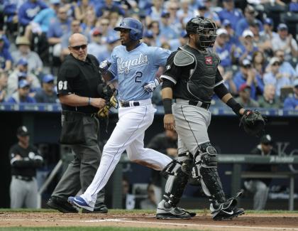 Alcides Escobar crosses home as he scores in the second inning Thursday. (Getty)
