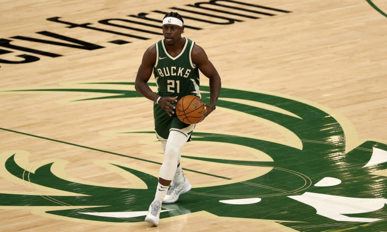 Jrue Holiday crosses half-court dribbling the basketball