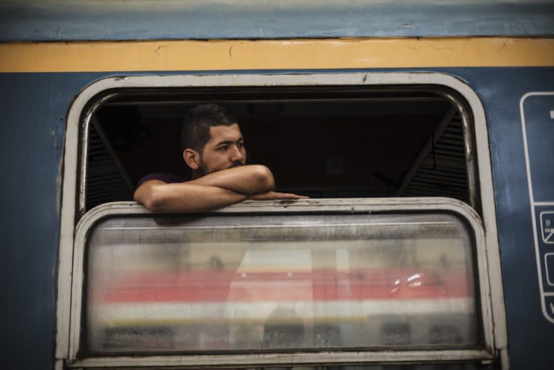 A Syrian migrant looks out a window of a train heading toward Vienna in the Keleti train station in Budapest, Hungary, on September 6, 2015. On April 4, 2014, the United Nations announced that the millionth refugee from war-torn Syria had entered Lebanon. File Photo by Achilleas Zavallis/UPI