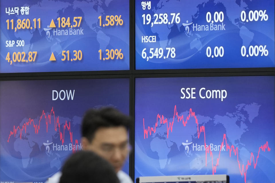 Currency traders talk near the screens at a foreign exchange dealing room in Seoul, South Korea, Wednesday, March 22, 2023. Asian shares advanced Wednesday after a Wall Street rally led by the banks most beaten down by the industry’s crisis.(AP Photo/Lee Jin-man)