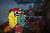 Sonali Begum, 17, left, consoles her mother-in-law Ashiya after her husband Siddique Ali, 23, was picked up by the police in Guwahati, India, Saturday, Feb. 4, 2023. Indian police have arrested more than 2,000 men in a crackdown on illegal child marriages in involving girls under the age of 18 a northeastern state. Begum is seven months pregnant. (AP Photo/Anupam Nath)