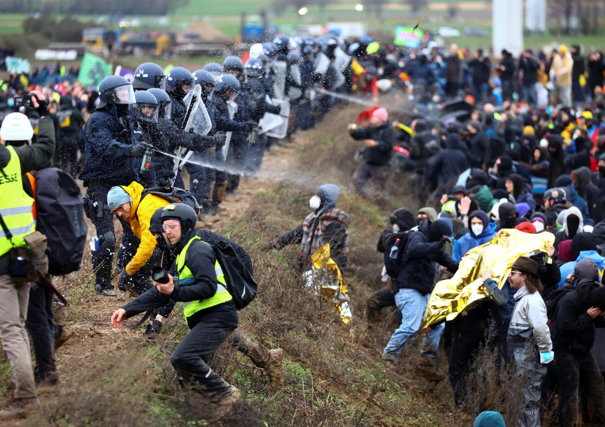 Polizisten drängen in Lützerath Demonstranten zurück, die gegen eine Räumung des Vom  Kohleabbau bedrohten Dorfes protestieren (Bild: REUTERS/Christian Mang)