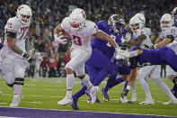 Washington State running back Deon McIntosh (3) scores a touchdown against Washington during the second half of an NCAA college football game, Friday, Nov. 26, 2021, in Seattle. (AP Photo/Ted S. Warren)