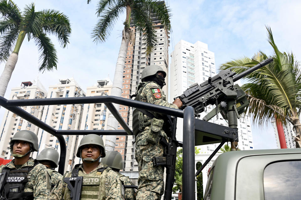 Mexican army infantry soldiers aboard military trucks patrol the streets in the tourist port of Acapulco, Guerrero state, Mexico during a security operation in the face of a growing wave of violence on June 20, 2024. / Credit: FRANCISCO ROBLES/AFP via Getty Images