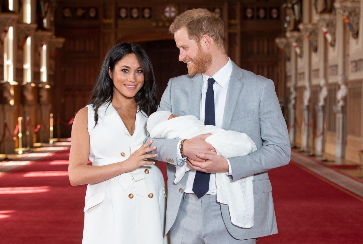 Britain's Prince Harry, Duke of Sussex (R), and his wife Meghan, Duchess of Sussex, pose for a photo with their newborn baby son, Archie Harrison Mountbatten-Windsor, in St George's Hall at Windsor Castle in Windsor, west of London on May 8, 2019. (Photo by Dominic Lipinski / POOL / AFP)        (Photo credit should read DOMINIC LIPINSKI/AFP via Getty Images)