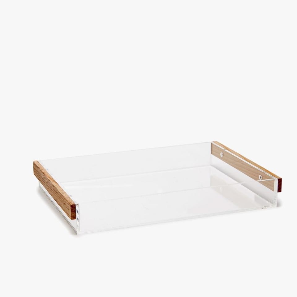 <p>Tired of the beauty products strewn across the top of your drawer? Organize them with this methacrylate tray — it'll keep everything visible, yet contained.</p> <p><strong>Shop It Here:</strong> Methacrylate tray with wooden handles, $25.90, <a rel="nofollow noopener" href="https://www.zarahome.com/us/kitchen-&-dining/trays/methacrylate-tray-with-wooden-handles-c1020117173p300477855.html?colorId=990&parentId=300482384" target="_blank" data-ylk="slk:zarahome.com;elm:context_link;itc:0;sec:content-canvas" class="link ">zarahome.com</a></p>