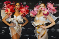 FILE - Lido dancers Alicia, left and Charlenne pose during a photo call at the Lido cabaret on the Champs-Elysees avenue to take part in the Crystal Globes awards ceremony in Paris, Monday, Dec. 30, 2016. It’s the end of an era for the famed Lido cabaret on Paris’ Champs-Elysees. Amid financial troubles and changing times, the venue’s new corporate owner is ditching most of the Lido’s staff and its high-kicking, high-glamour dance shows. (AP Photo/Francois Mori, File)