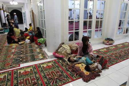 Residents affected by the floods rest as they sheltered at a mosque in Bengkulu, Indonesia, April 28, 2019. Picture taken April 28, 2019. Antara Foto/David Muharmansyah/ via REUTERS