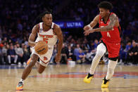 New York Knicks guard Immanuel Quickley (5) drives to the basket past Houston Rockets guard Jalen Green during the second half of an NBA basketball game Monday, March 27, 2023, in New York. (AP Photo/Adam Hunger)