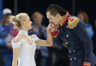 Maxim Trankov kisses the hand ofTatiana Volosozhar of Russia at the end of their performance during the Team Pairs Short Program at the Sochi 2014 Winter Olympics, February 6, 2014. REUTERS/Lucy Nicholson