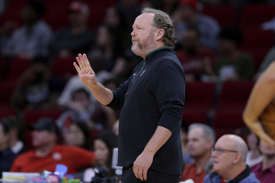 Milwaukee Bucks head coach Mike Budenholzer gestures at the bench during the first half of an NBA basketball game against the Houston Rockets, Sunday, Dec. 11, 2022, in Houston. (AP Photo/Michael Wyke)