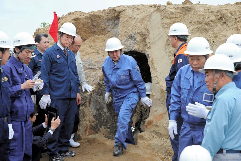 FILE PHOTO: Japanese PM Abe inspects what is believed to be a dugout made by Japanese soldiers during World War II in Iwo Jima